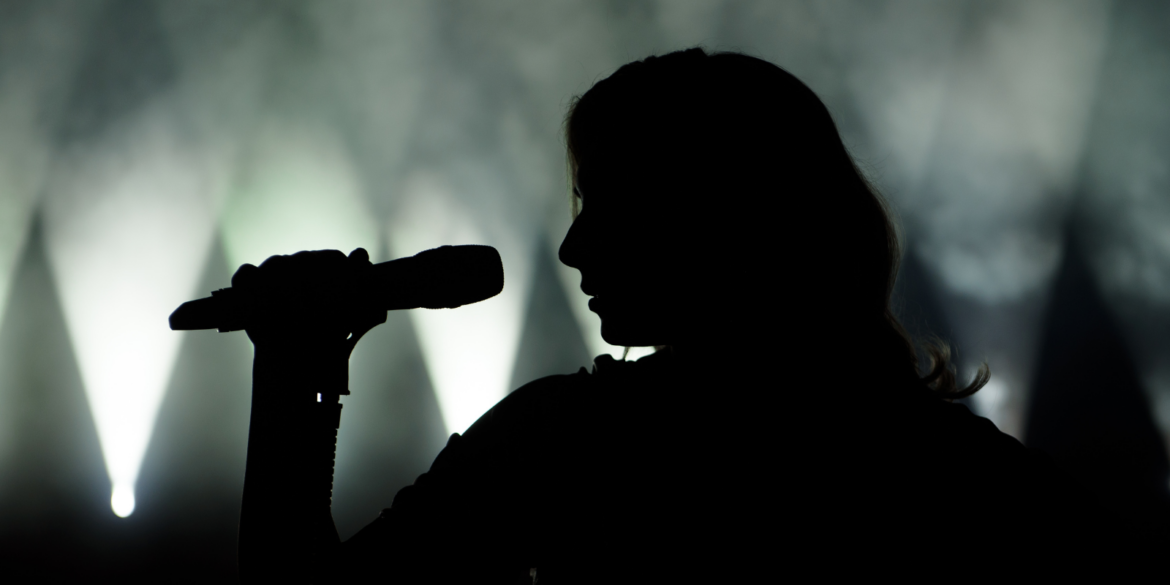 Woman singing in silhouette